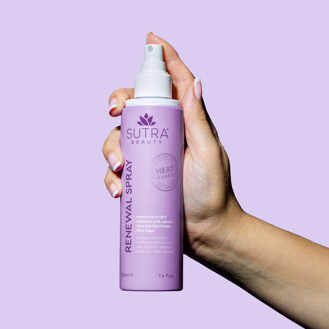 hand-holding-heat-guard-renewal-spray-lavender-bottle-white-nozzle