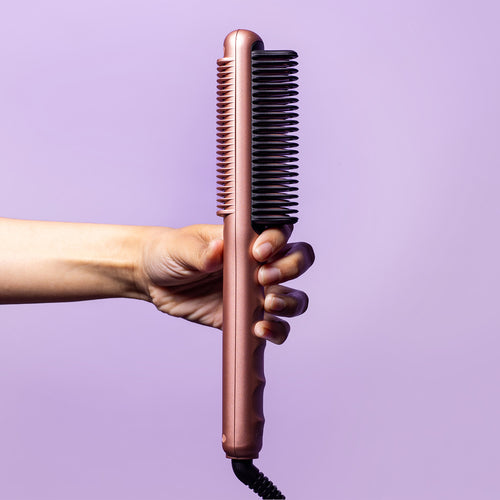 Hand-holding-rose-gold-ez-glider-styling-comb-white-background