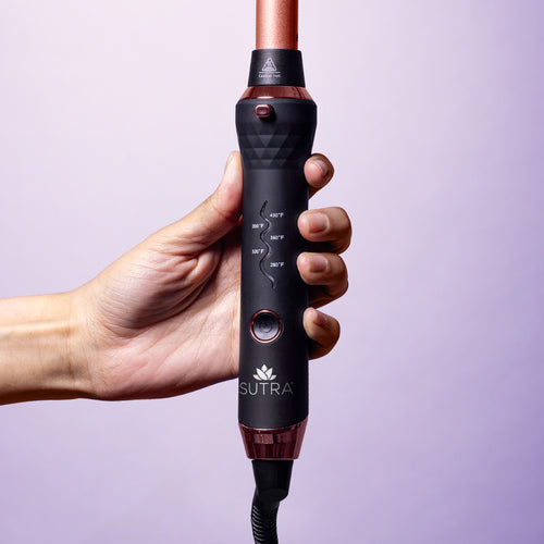 hand-holding-interchangeable-curler-base-5-heat-settings-power-button-quick-release-button