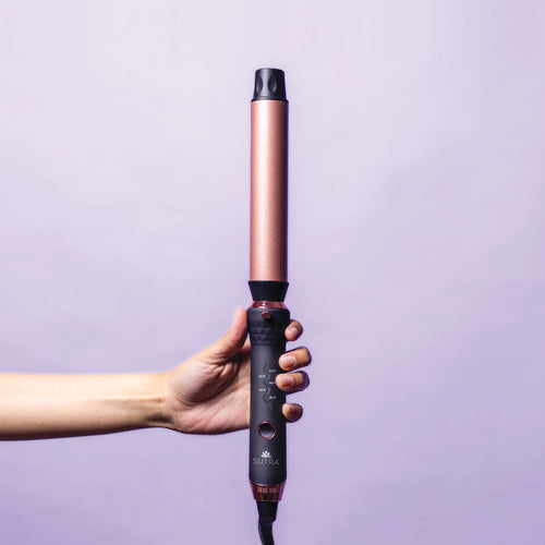 hand-holding-interchangeable-curler-base-with-32mm-clipless-barrel-attached