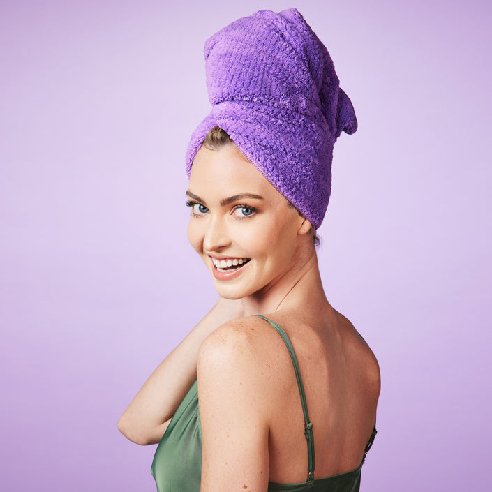 blonde-hair-model-wearing-purple-microfiber-towel-on-head-smiling